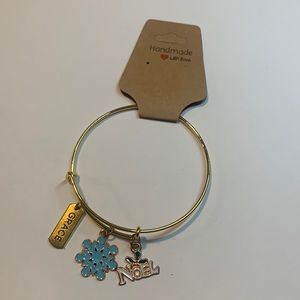 Handmade gold tone stainless steel bracelet with 3 charms.